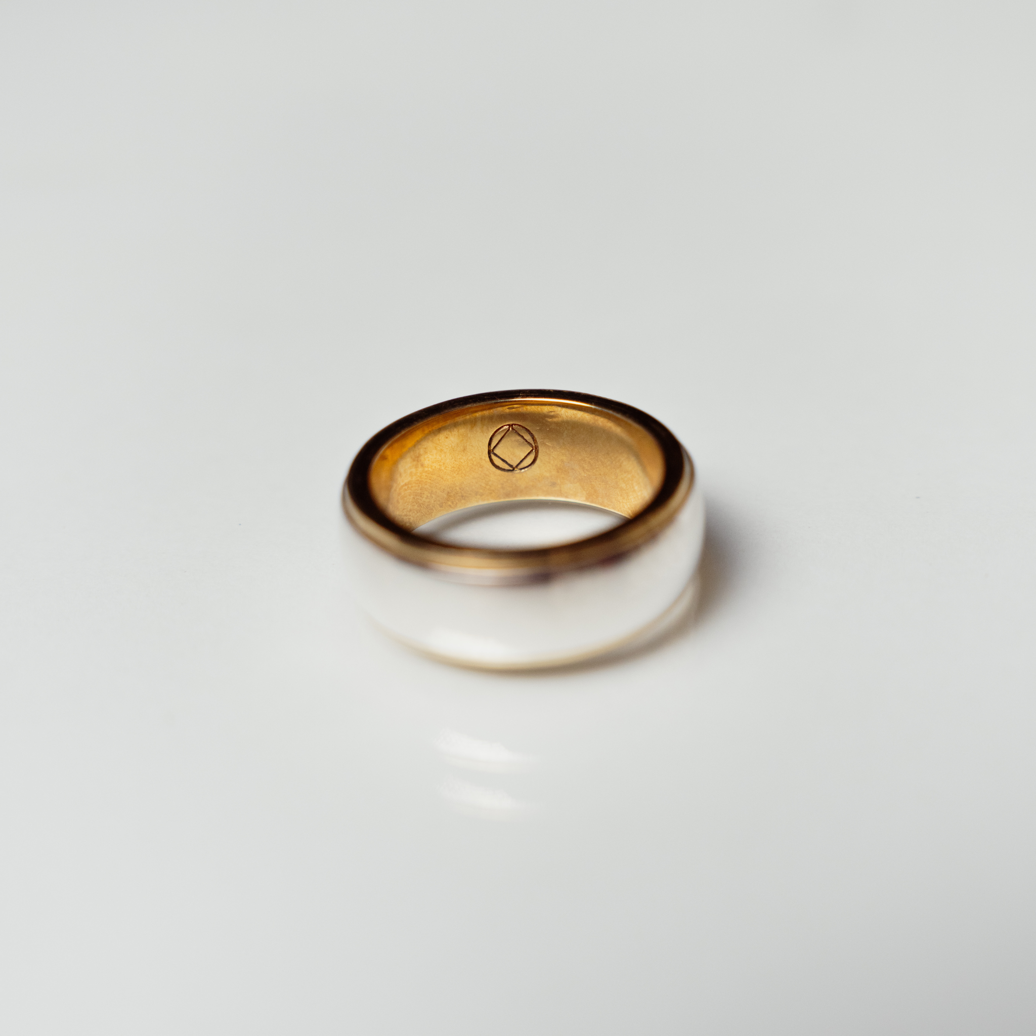 The Jake ring anxiety ring with bronze inside and silver spinning ring on outside on white background