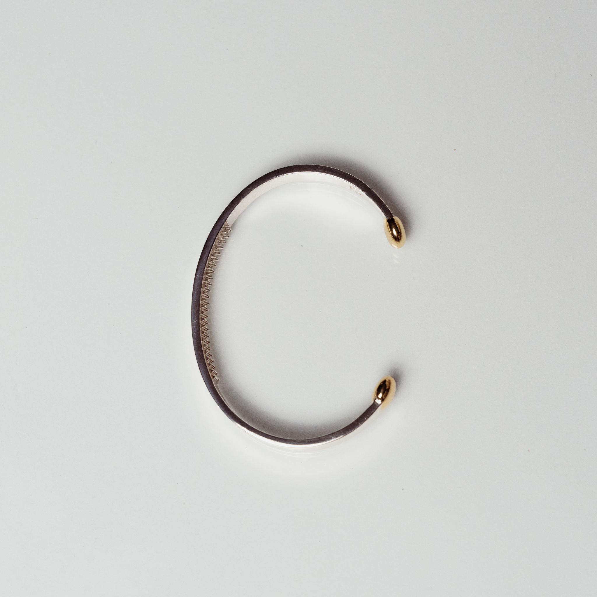 The Annika cuff anxiety bracelet in silver and bronze on white background