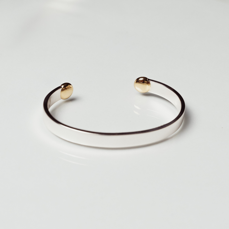 The Annika cuff anxiety bracelet in silver and bronze on white background