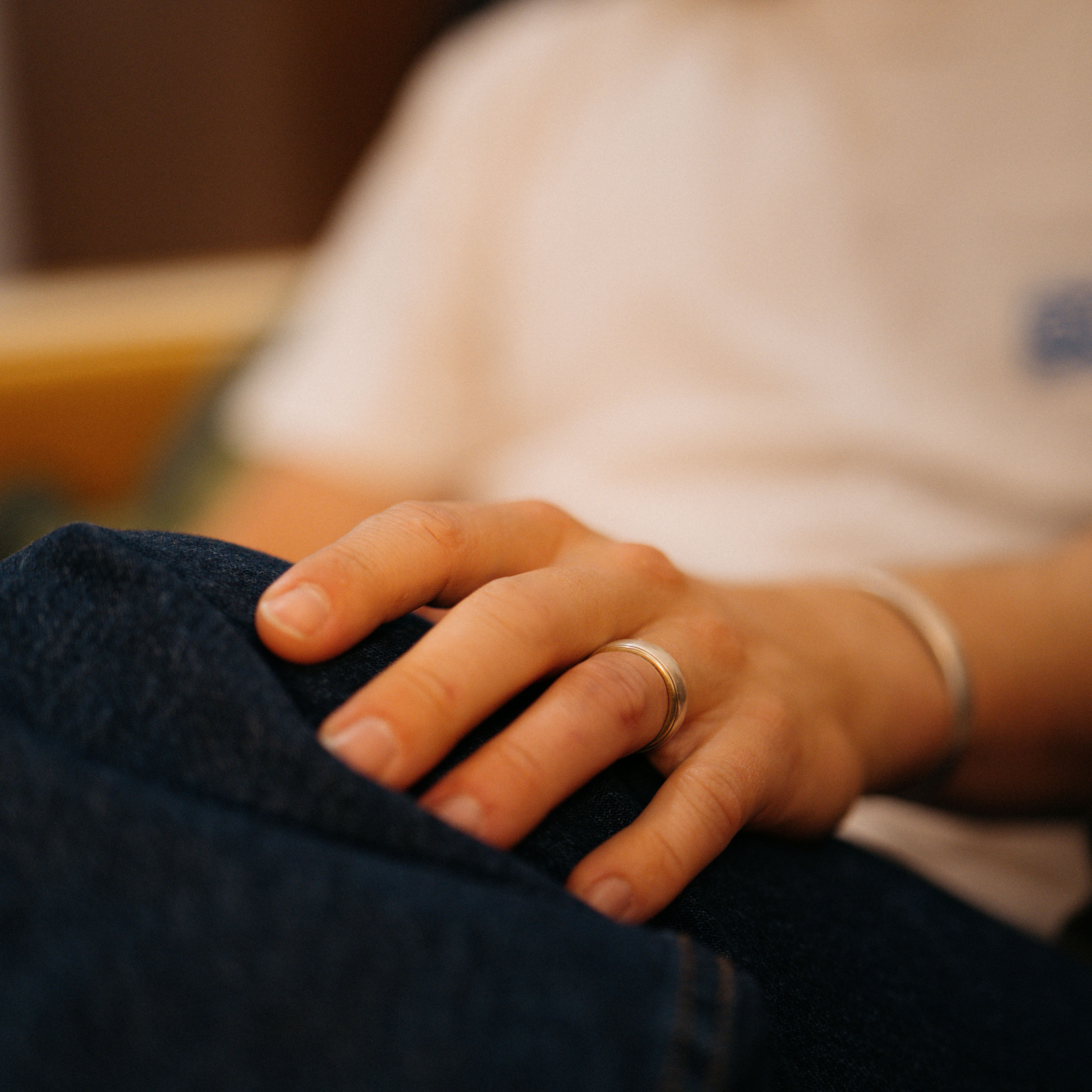 The Jake ring anxiety ring with bronze inside and silver spinning ring on outside being worn on guys finger