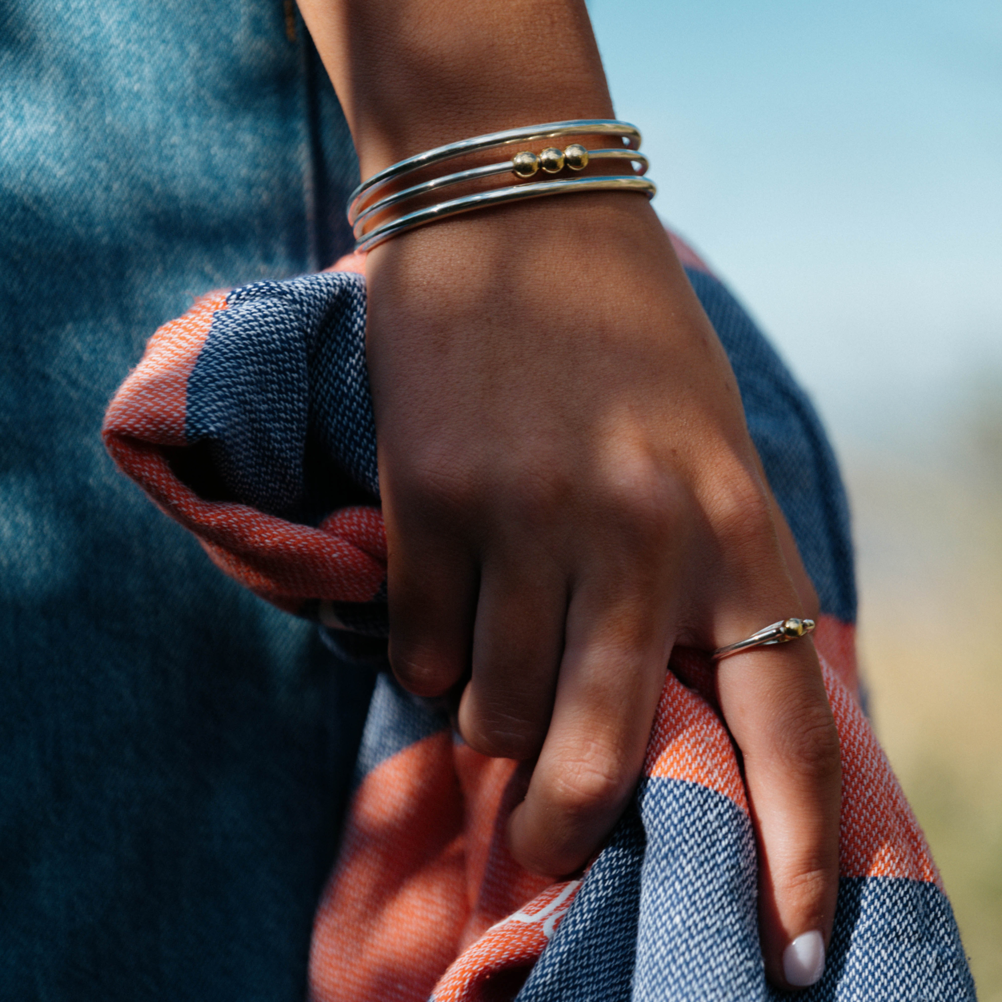 A white hand wearing the Winda bangle from Star & Co Anxiety jewellery